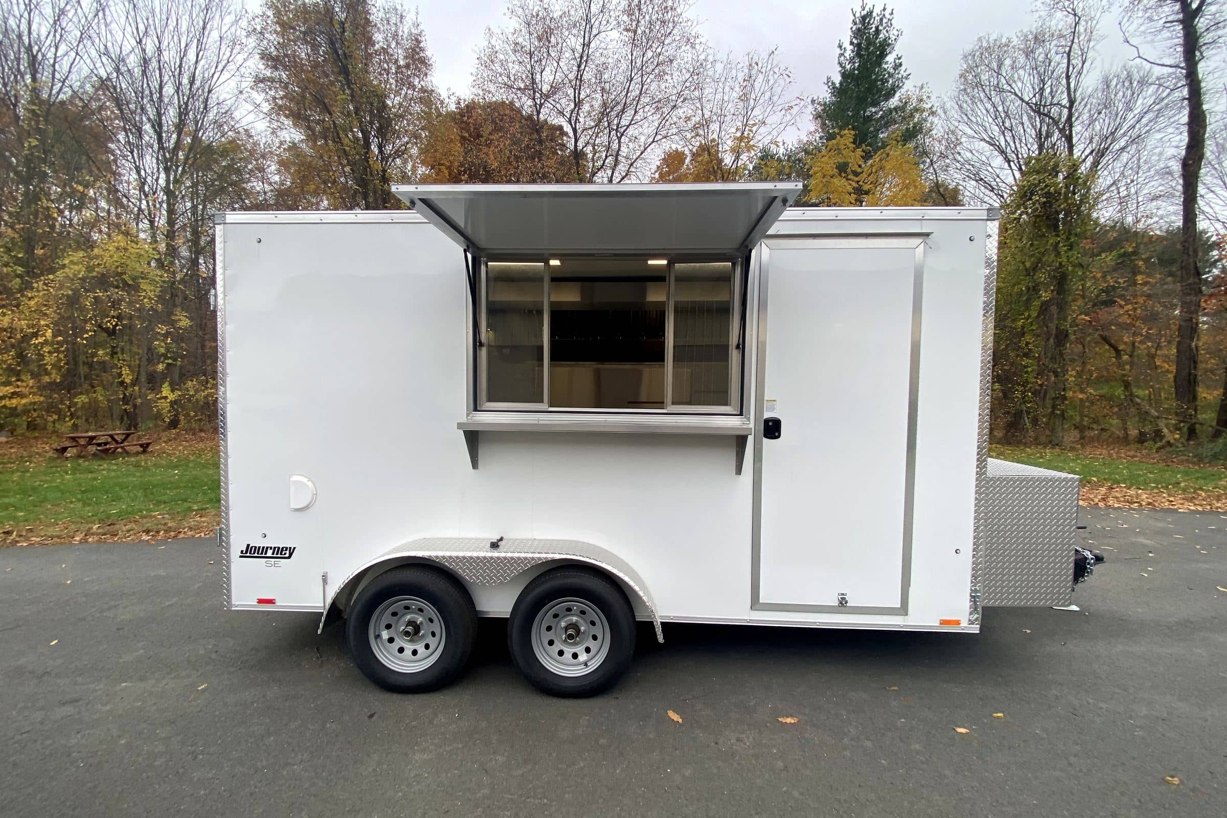 White taco concession trailer with the serving window open